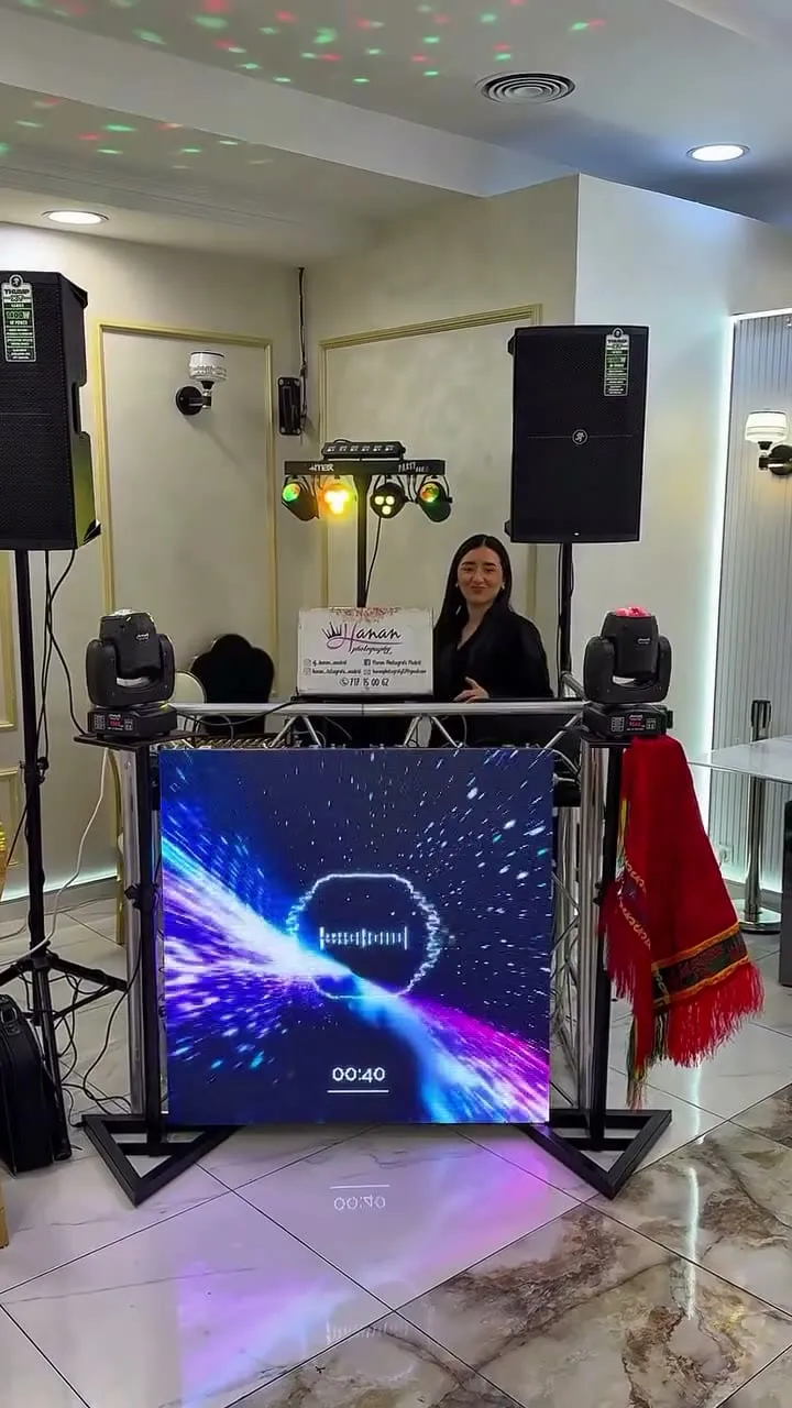 DJ Hanan en su cabina con luces robotizadas y pantalla LED